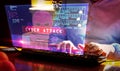 Hacker typing on keyboard with breaking security and code on hologram screen