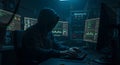Anonymous Hacker Working on Multiple Screens in Dark Room Royalty Free Stock Photo