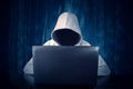 Hacker typing on a laptop with binary code in background Royalty Free Stock Photo