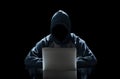 Hacker typing on a laptop isolated on black background with a computer monitor background matrix, Digital data code in security Royalty Free Stock Photo