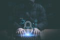 Hacker typing on laptop keyboard with padlock in concept of cyber security internet privacy data protection Royalty Free Stock Photo