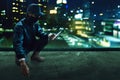 Hacker use mobile phone on rooftop Royalty Free Stock Photo