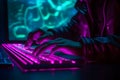 Hacker uses keyboard, shakes buttons with fingers to crack password. Internet security concept, cyber attack. Neon blue