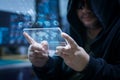 Hacker using clear tablet with HUD panel and code graph bar data Royalty Free Stock Photo