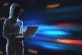 Hacker using laptop with abstract binary code on blurry background. Cyber attack and hacking concept. Royalty Free Stock Photo