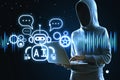 Hacker using laptop with creative glowing robot ai hologram on dark background. Automated machine learning, hacking and artificial Royalty Free Stock Photo