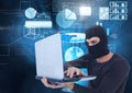 Hacker using a laptop in front of digital background Royalty Free Stock Photo