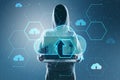 Hacker using laptop with glowing hexagonal cloud computing hologram with binary coding on blurry backdrop. Safety, hacking, Royalty Free Stock Photo