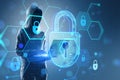 Hacker using laptop with glowing hexagonal padlock hologram with binary coding on blurry background. Safety, hacking, malware and Royalty Free Stock Photo