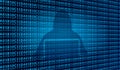 Hacker using laptop on hexadecimal and binary code blue background symbolizing data breach and cyber attack Royalty Free Stock Photo