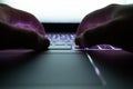 Hacker using laptop. Lots of digits on the computer screen Royalty Free Stock Photo