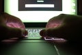 Hacker using laptop. Lots of digits on the computer screen Royalty Free Stock Photo