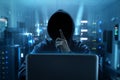 Hacker using laptop in sever room Royalty Free Stock Photo