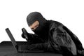 Hacker using magnifying glass on a laptop computer Royalty Free Stock Photo