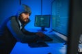 Hacker Using Multiple Computers For Stealing Data On Desk Royalty Free Stock Photo