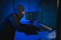 Hacker Using Multiple Computers For Stealing Data On Desk Royalty Free Stock Photo