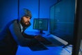 Hacker Using Multiple Computers For Stealing Data On Desk Royalty Free Stock Photo