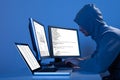 Hacker using multiple computers to steal data Royalty Free Stock Photo