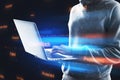 Hacker using notebook with abstract binary code on blurry background. Cyber attack and hacking concept. Royalty Free Stock Photo