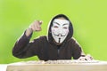 Hacker with vendetta mask and threatening gesture