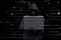 Hacker with vendetta mask typing on a laptop Royalty Free Stock Photo