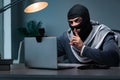 The hacker wearing balaclava mask hacking computer Royalty Free Stock Photo