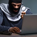 Hacker wearing balaclava mask hacking computer