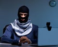 Hacker wearing balaclava mask hacking computer Royalty Free Stock Photo