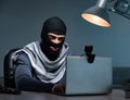Hacker wearing balaclava mask hacking computer Royalty Free Stock Photo