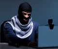 Hacker wearing balaclava mask hacking computer Royalty Free Stock Photo