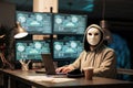 Hacker wearing mask and hood to hack computer