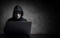 Hacker wearing a white mask in front of his computer. hacker hacks network Royalty Free Stock Photo