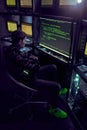 Hacker is working with computer typing text in dark room. Royalty Free Stock Photo