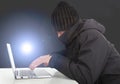 Hacker working with a laptop computer in the darkness Royalty Free Stock Photo