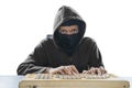 Hacker working with mask and vintage keyboard