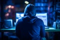 Hacker works at a computer, back view