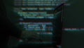 Hacker writing code cracking computer. Programming code in the background. Hacker attack, cybercrime, virus software, dark web,