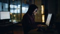 Hacker writing data computer keyboard in night high-tech room alone closeup Royalty Free Stock Photo