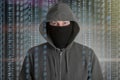 Hackers programmer look on screen and writes the program code hack information