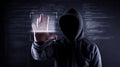 Hackers wear a cloak, not see the face, are scanning hands. Royalty Free Stock Photo