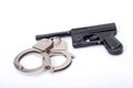 Hadcuffs and gun Royalty Free Stock Photo