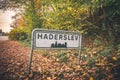 Haderslev city sign by a road in Denmark