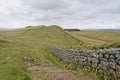 Hadrians Wall crossing the rugged Northumbrian landscape Royalty Free Stock Photo