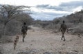 Hadzabe men with their bows and arrows going for a hunt in early morning Royalty Free Stock Photo