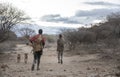 Hadzabe men with their bows and arrows going for a hunt in early morning Royalty Free Stock Photo