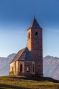 Hafling, Italy - The mountain church of St. Catherine near Hafling - Avelengo on a warm autumn sunset