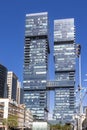 Hagag Group twin skyscrapers. Closeup. Blue sky and white clouds. Shot from below. Designed: Moshe Zur Architects and Urbanists