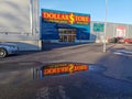 Hagfors, Sweden October 2022. Dollarstore shop front, with reflection in a water pond.