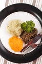 Haggis with mashed potato, turnip and parsley on a plate