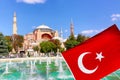 Hagia Sophia Ayasofya museum with fountain in the Sultan Ahmet Park in Istanbul, Turkey with a turkish flag during sunny summer Royalty Free Stock Photo